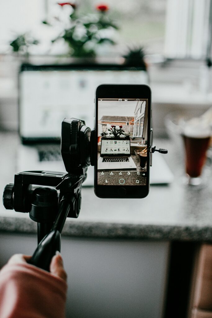 Creative setup using mobile phone for capturing a workspace scene, emphasizing smartphone photography.